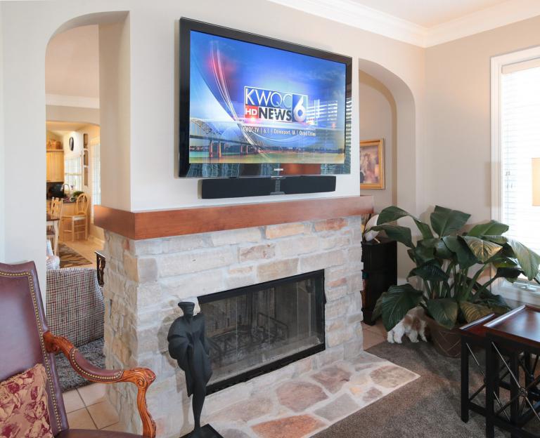 Flat screen TV above fireplace